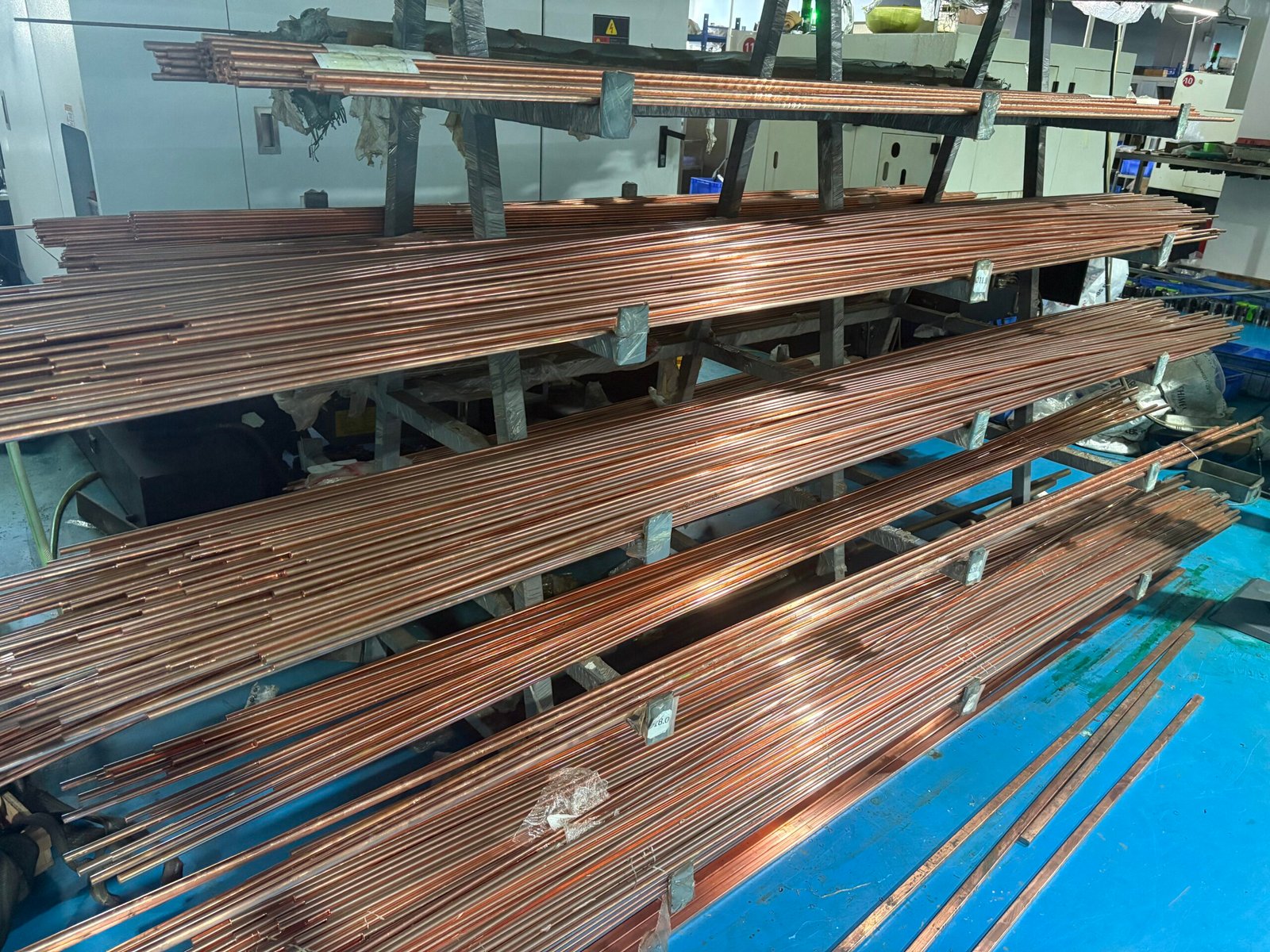 High-purity oxygen-free copper rods stored on industrial racks at Zhongzhen factory